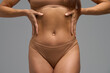 © Sergey Mironov - Close-up of woman with hands on waist showing muscle soreness and body awareness
