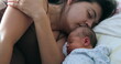 © Marco - Newborn baby and mother sleeping together in bed, candid real life family moment