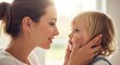 © Evelyn - A mother gently holds her toddler's face while looking into their eyes.