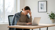 © Abul Kalam Azad - young professional woman stressed while working on laptop at bright home office desk