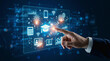 © Raul - Hand touches holographic interface displaying education, finance, and technology icons on digital screen.