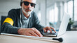 © Fotosphaere - Blind man with walking stick using a laptop computer.