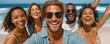 © Georgii - Group of friends smiling and enjoying a sunny beach vacation together