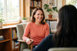© Meow Creations - Female therapist smiling while listening to patient in counseling session