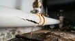 © Muhammad Saqib - Leaking PVC water pipe damage and plumbing repair emergency in residential kitchen. Featuring cracked plumbing system with water dripping under sink and visible mold growth for home