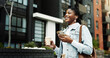 © peopleimages.com - Happy, black woman or travel with coffee, phone or music in city for morning commute to work. Female person, traveler or smile with earphones, beverage or smartphone for audio streaming in urban town
