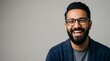 © Syauqiya - Portrait of a cheerful man with glasses and a beard.