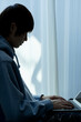 © arc image gallery - ノートパソコンを操作する若い日本人男性のシルエット