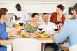 © JackF - Multicultural female and male friends chatting and drinking wine at table