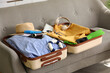 © Pixel-Shot - Open suitcase with men's swimwear, beach accessories and passport, closeup