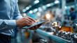 © Kateryna - Hands of chief technical officer using tablet to monitor manufacturing process while walking through production facility young specialist in work attire inspecting metal
