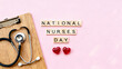 © Abdelati - National Nurses Day greeting with stethoscope and wooden letter tiles, medical appreciation concept on pink background, healthcare worker tribute isolated on White Background