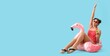 © Pixel-Shot - Happy African-American woman in swimsuit, with cocktail sitting on swimming ring against light blue background with space for text