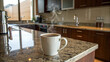 © Thamonchanok - Kitchen with granite island design concept. A steaming cup of coffee on a kitchen countertop exudes warmth.