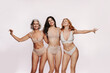 © Jacob Lund - Three women in studio embracing wearing nude lingerie