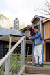 © wavebreak3 - African American father and son leaning on handrail with metal cables on deck steps, copy space