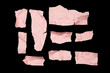 © M_Yunus - Pink torn or ripped paper scraps with various shape lie scattered isolated on black background.