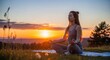 © Maeva - young woman meditating at sunset in serene outdoor field with golden light