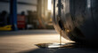 © SashaMagic - Leaking fuel tank drips gasoline onto concrete floor in dramatic automotive workshop scene