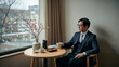 © bephoto - 窓辺の桜を眺めながら春の弁当時間を過ごす日本人男性