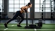 © antuanetto - Determined athletic woman pushing a heavy weight sled in a modern gym for a female empowerment and functional strength fitness concept