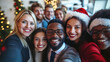 © Wendy - Diverse group of happy young business people or friends taking a selfie photo on smartphone during a christmas party in a modern office.
