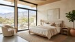 © aulia - Modern desert bedroom with beige decor and mountain view through large windows and sliding glass doors.