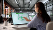 © Andrey Popov - Woman At Office Computer Reviewing Fire Evacuation Plan