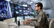 © Andrey Popov - Military Officer Studies Data On Computer Desk
