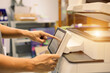 © Jintana - Office men use photocopy or copier machine at workplace is equipment for make a copy paper or photocopier for scanning document and photocopying service maintenance concepts.