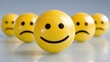 © Chung - Four yellow emoji balls on reflective light gray surface soft light blue gray background, front to back依次为 sad happy angry worried, sharpness decreasing