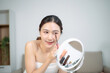 © laddawan - Asian beauty blogger applying makeup in mirror at home, skincare routine and cosmetic review, natural glow lifestyle, influencer content
