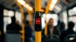 © Masque - A detailed close-up of a red stop button inside a city bus with blurred passengers.