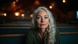 © svastix - A mature woman with long, silver hair sits thoughtfully in a quiet space, inviting reflection on life experiences, wisdom, and the beauty of aging gracefully with dignity.