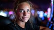 © svastix - This vibrant image features a young woman smiling at the camera, set against a backdrop of colorful casino lights, capturing the excitement of the gaming environment.
