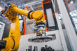 © Andrei Armiagov - Industrial robotic arm holding metal gear component in automated factory cell.