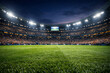 © designHub  - Soccer stadium with a full crowd at night illuminated field and large video screen