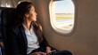 © DIAH  - Professional woman looking out airplane window, contemplating journey and business travel