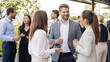 © 123sasha - People gather for networking event on a outdoor terrace during a sunny day in a city