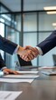 © MdAshik - Successful Business People Finalizing a Joint Venture with a Confident Handshake in a Corporate Setting