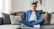 © Danukk Kimpetik - Young Man Relaxing on Sofa at Home.