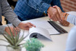 © peopleimages.com - Business people, meeting or handshake with documents for contract agreement or partnership. Group, employees or colleagues shaking hands with paperwork or signature for b2b or onboarding in workplace