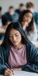 © Andrii Zastrozhnov - Female student writing exam in classroom with seated peers
