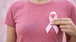 © JasmineStudio - Woman wearing pink shirt holding white ribbon for breast cancer awareness campaign