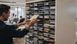 © Justlight - Focused medium shot of staff placing documents into labeled mail slots on a centralized rack while the busy room beyond appears blurred.