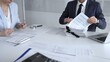 © volha_r - Professional accountant team analyzing corporate financial data, managing paperwork, and preparing tax reports, collaborating on bookkeeping and auditing tasks at a desk. Audit and taxes