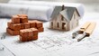 © fahad - Blueprint of Dreams: A miniature house sits amidst construction tools, bricks, and architectural blueprints, representing the meticulous planning and tangible steps of building a home.