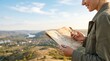 © velikiyzayats - Young woman hiker holding vintage map and compass looking at scenic valley landscape