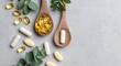 © oksa_studio - Dietary supplements, omega-3, and vitamin capsules on wooden spoons with green herbs, promoting health and wellness