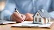 © rapli - Signing a contract for a new home with a model house